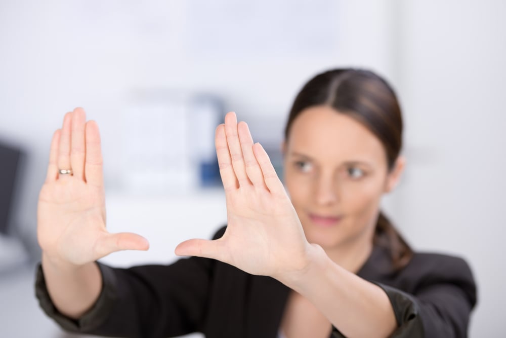 woman holding her hands up as a frame